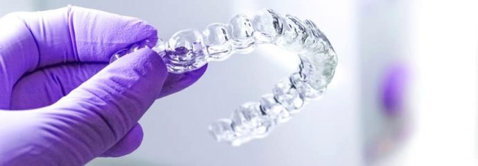 dentist holding invisalign tray