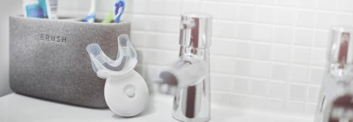 mouthpiece toothbrush in a bathroom next to a sink
