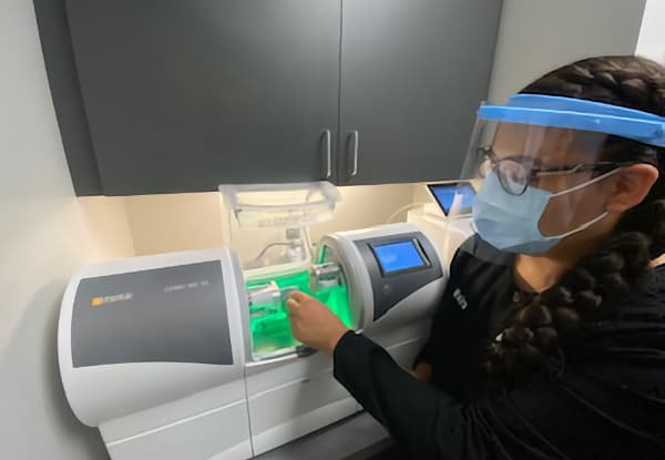 woman with CEREC machine in our longmont office