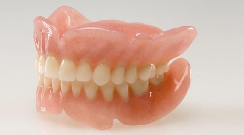 complete dentures showing both the upper and lower arch on a white background