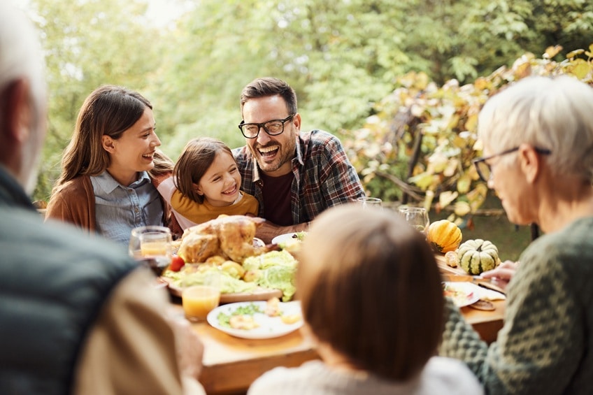 family enjoying dinner together outside