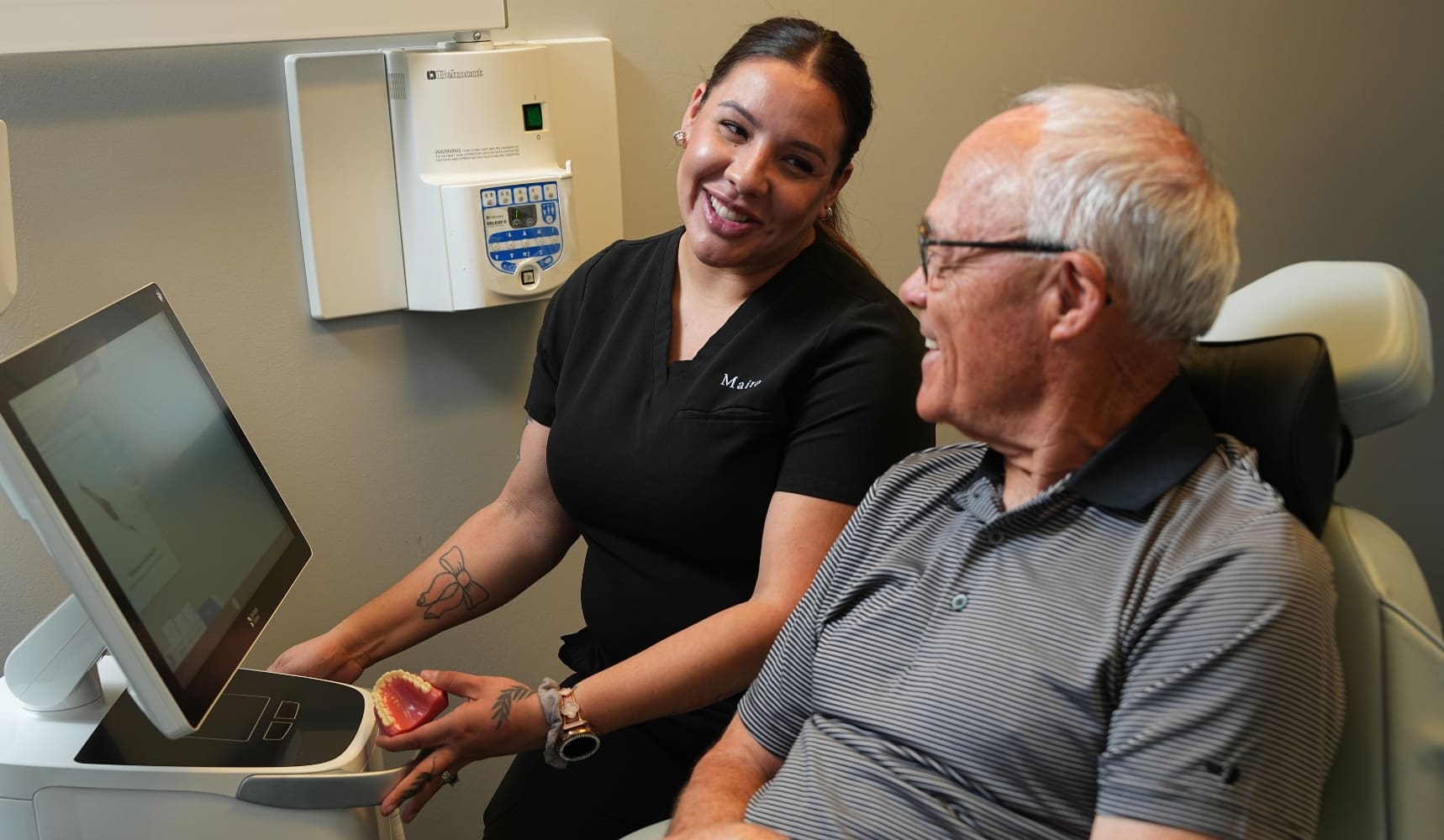 Maira reviewing a dental model with a patient during a general dentistry visit