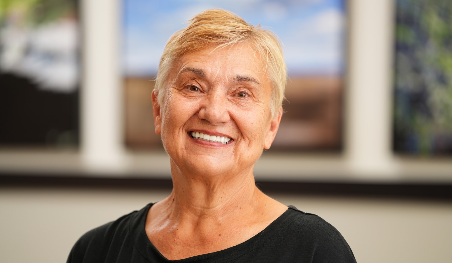 Marianne, a Longmont Dental Loft patient smiling after receiving cosmetic dentistry and full-mouth restorative treatment